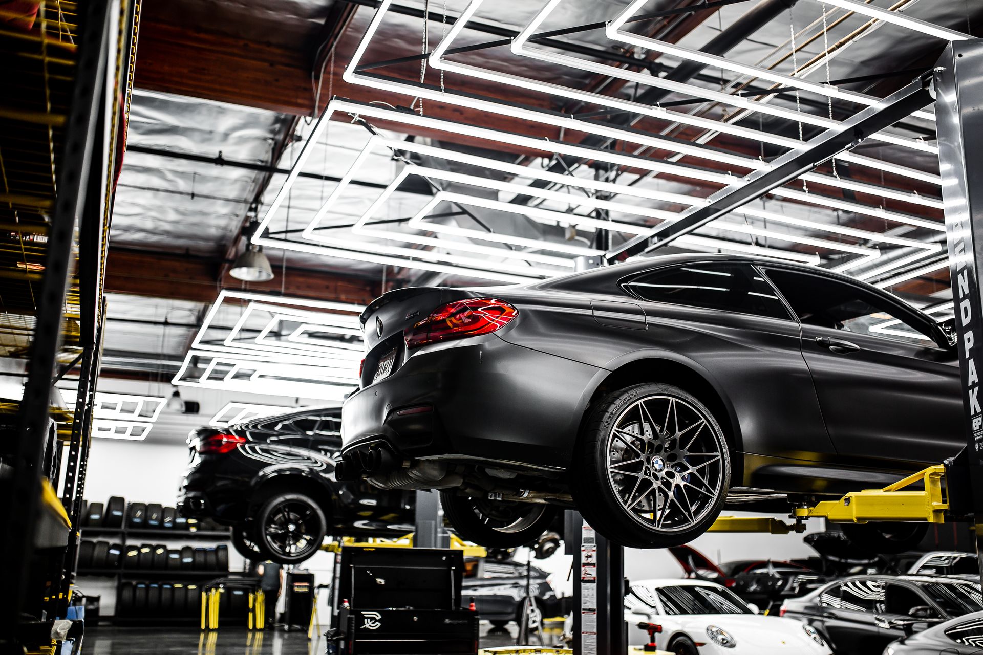 Car being repaired on a lift inside the workshop