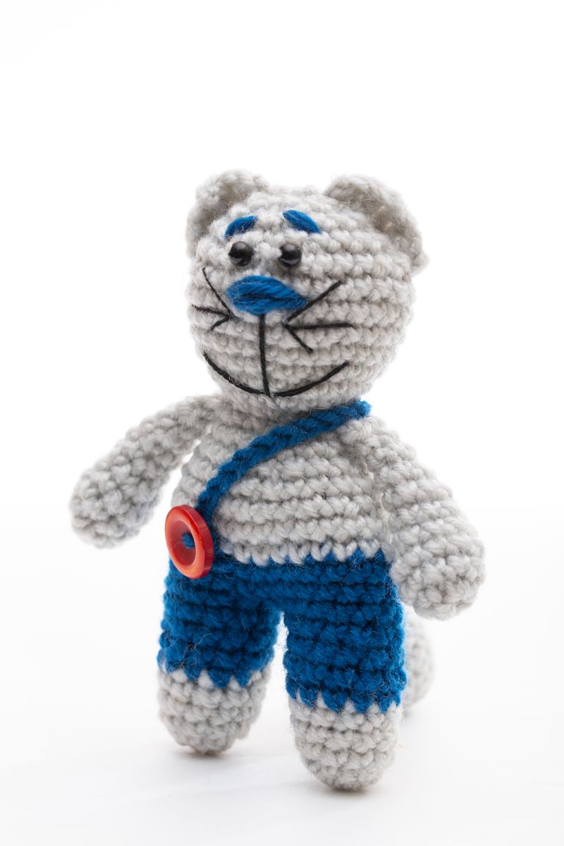 Handmade crochet bear in blue dungarees