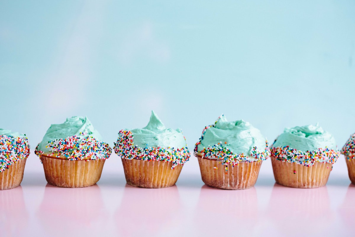 Pastel iced cupcakes with sprinkles