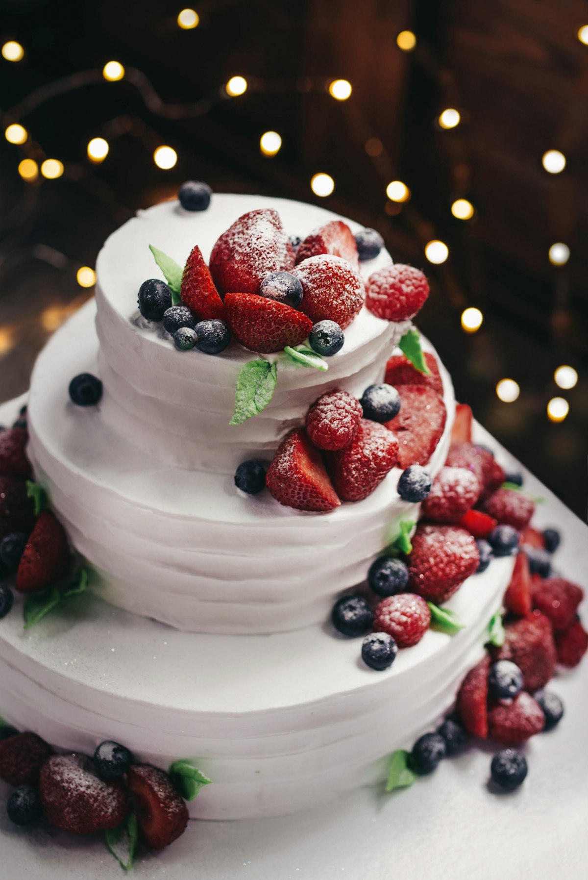 Handmade tiered cake decorated with fresh berries
