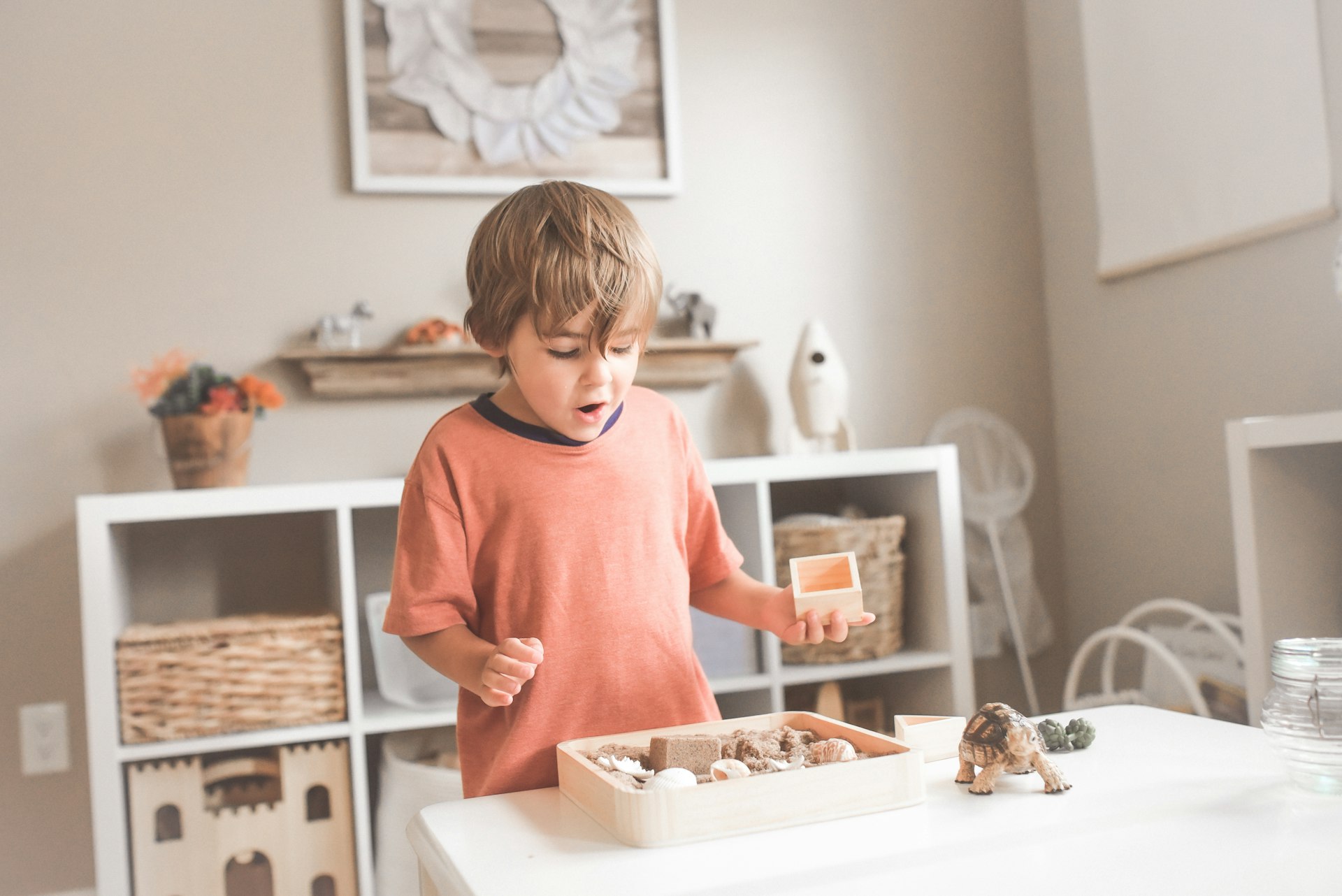Child engaged in Montessori sensory play at Kiddies Den Montessori