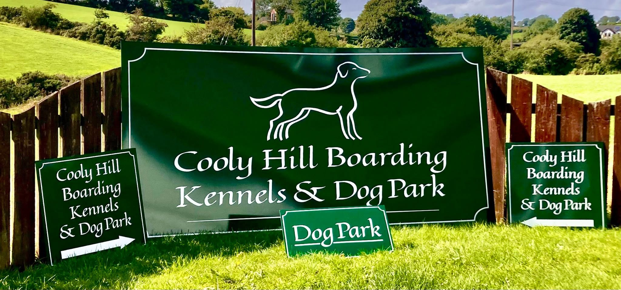 Large outdoor banner and directional signs for Cooly Hill Boarding Kennels & Dog Park