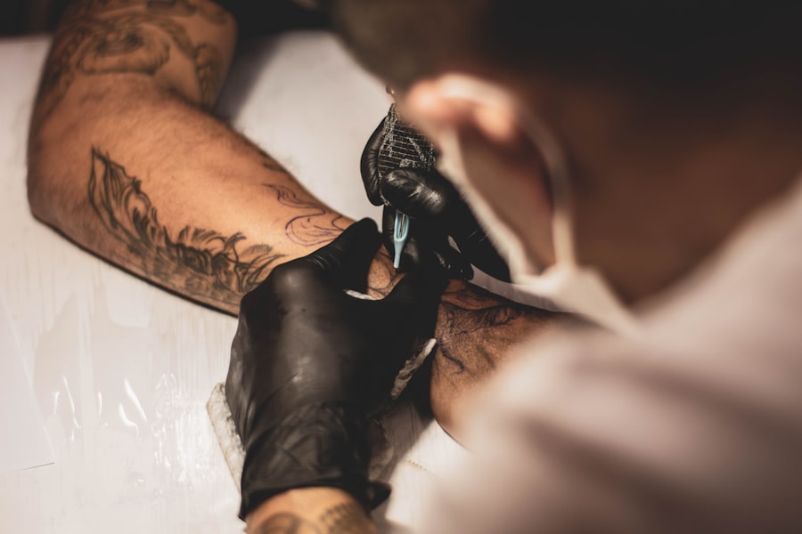 Tattoo artist working on a client's arm