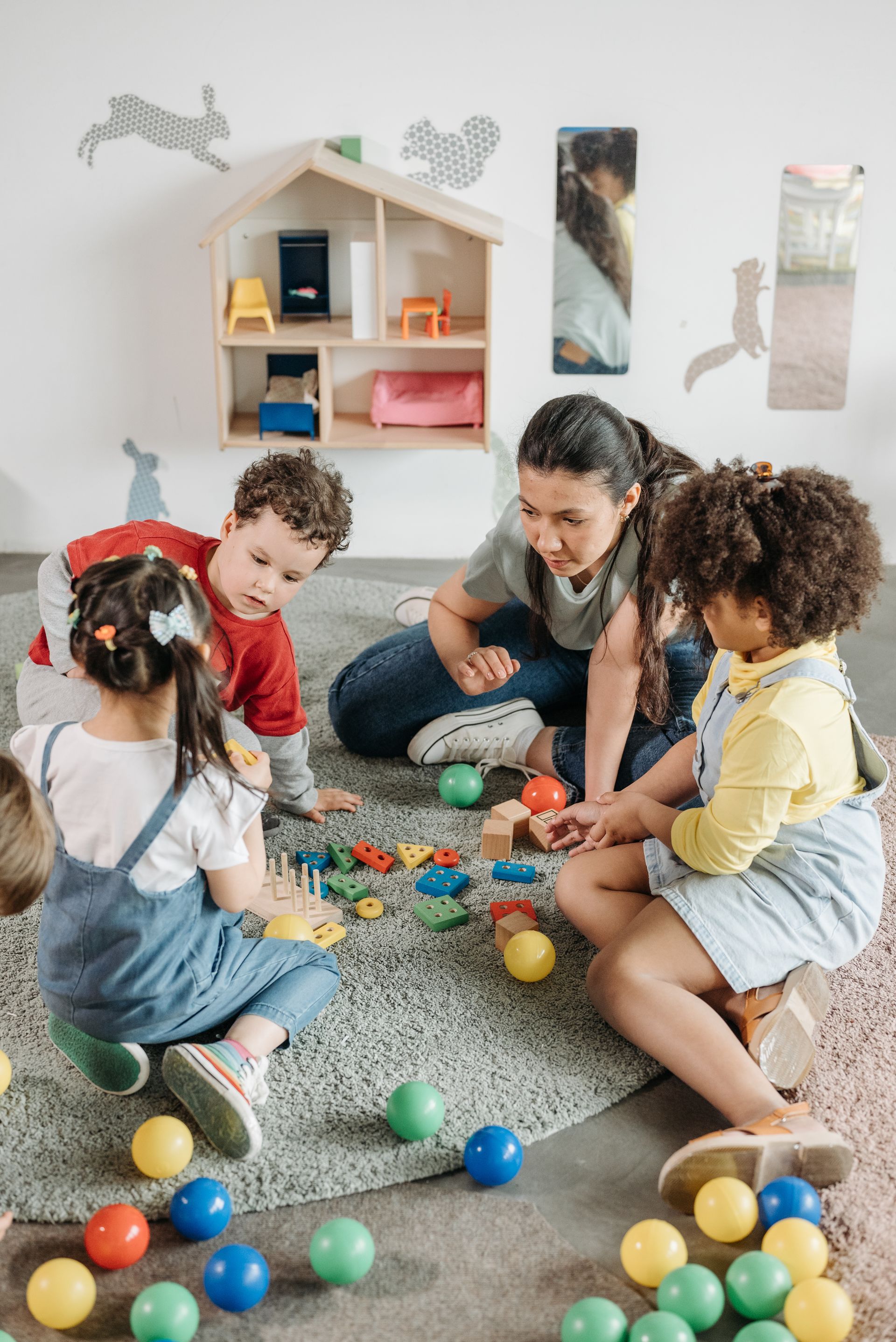 Rising Stars Childcare practitioner playing with children