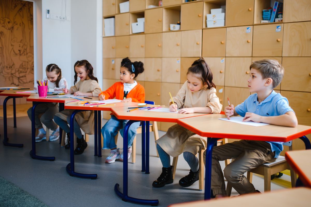 School-age children drawing during afterschool care at Rising Stars Childcare