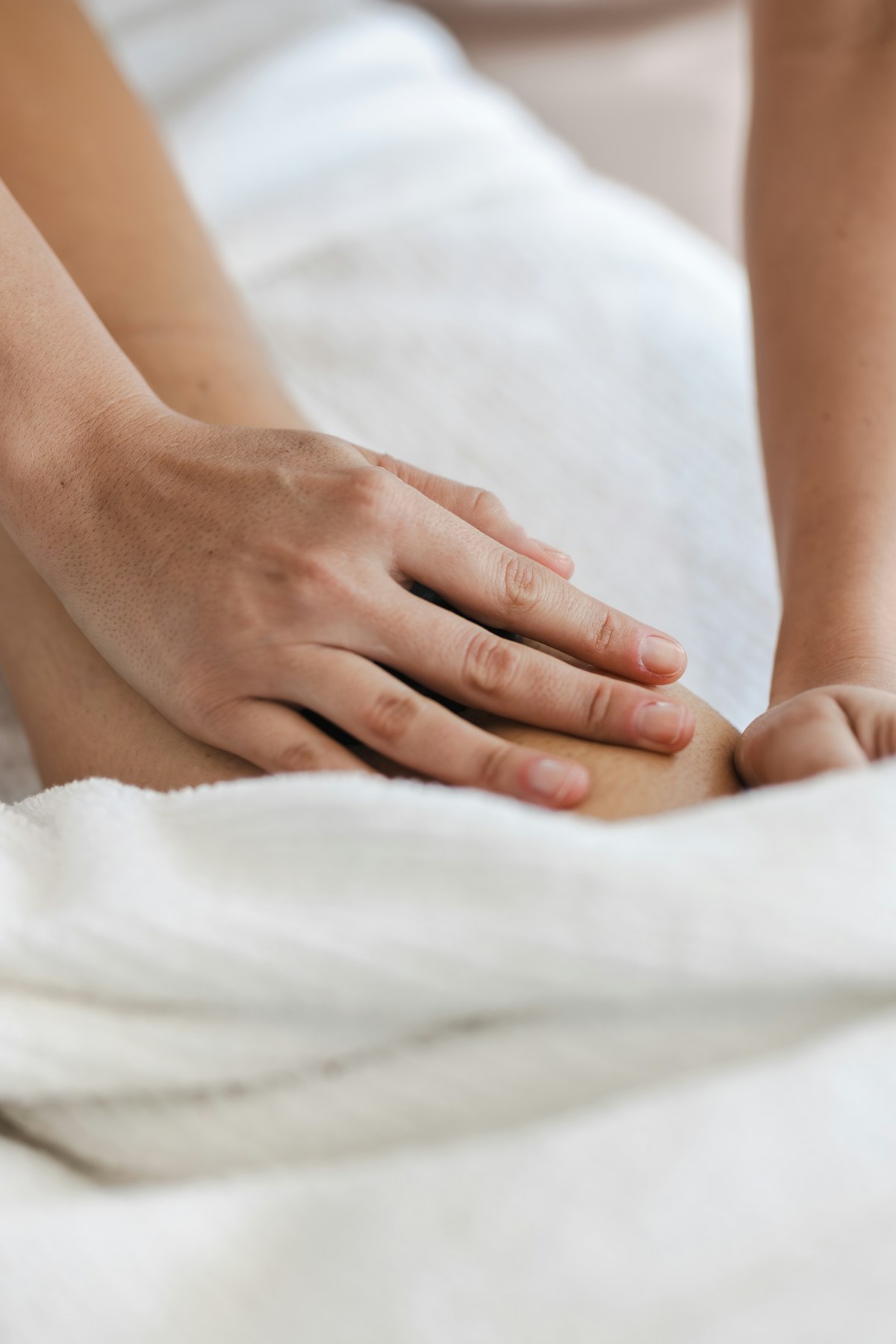 Sean Dineen treating a client's knee during a sports massage session in Antrim