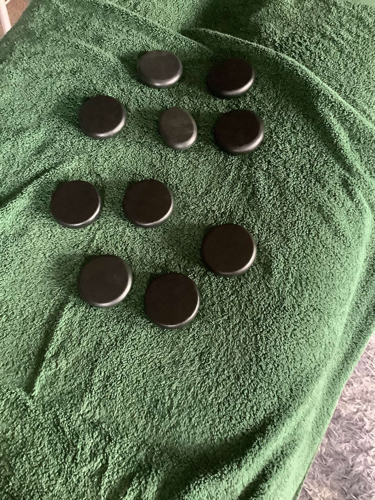 Hot stones laid out on a massage table, ready for a hot stones treatment