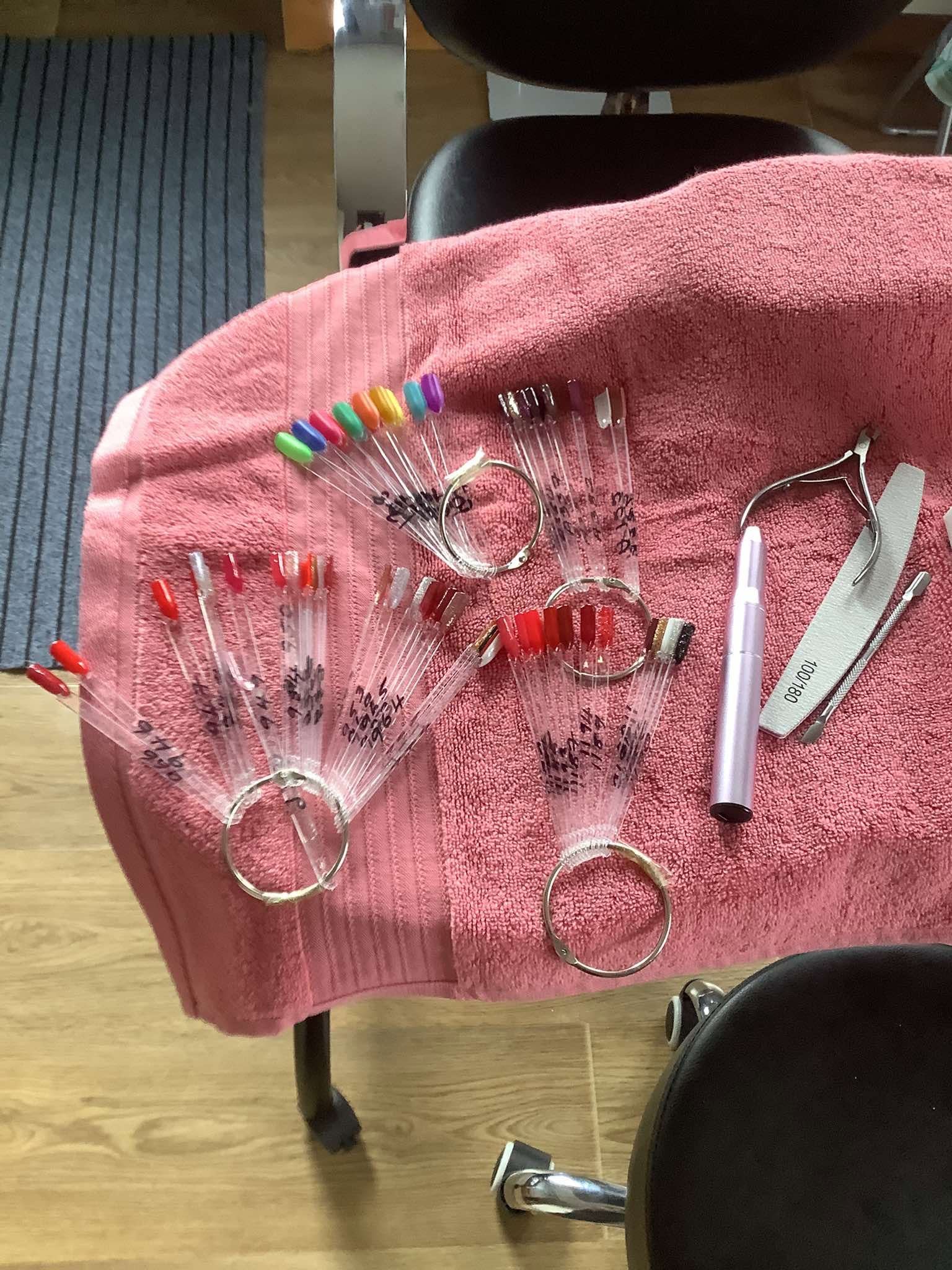 Nail polish colours and manicure tools set out for a treatment