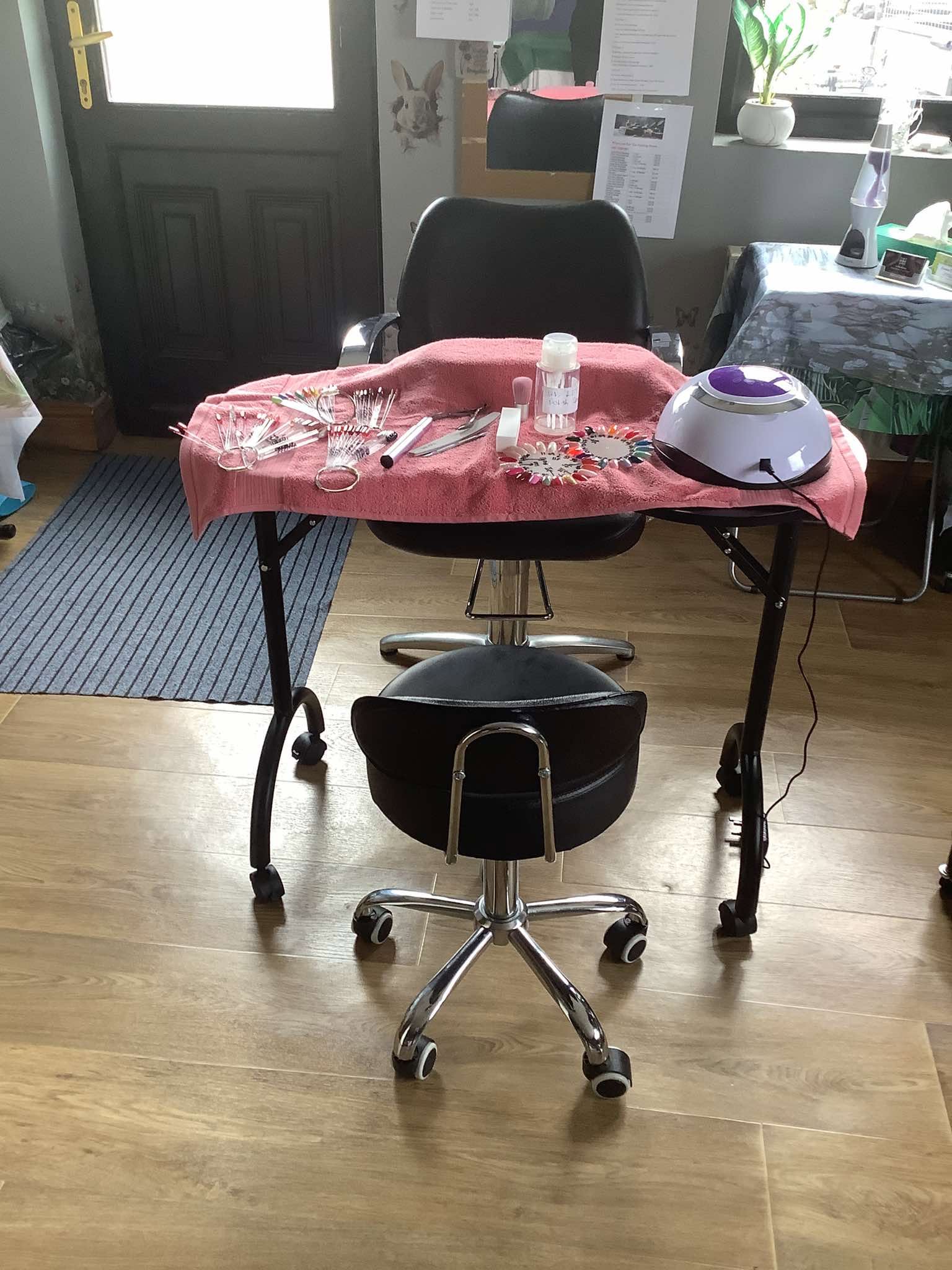 Manicure table with tools and UV lamp ready for a client