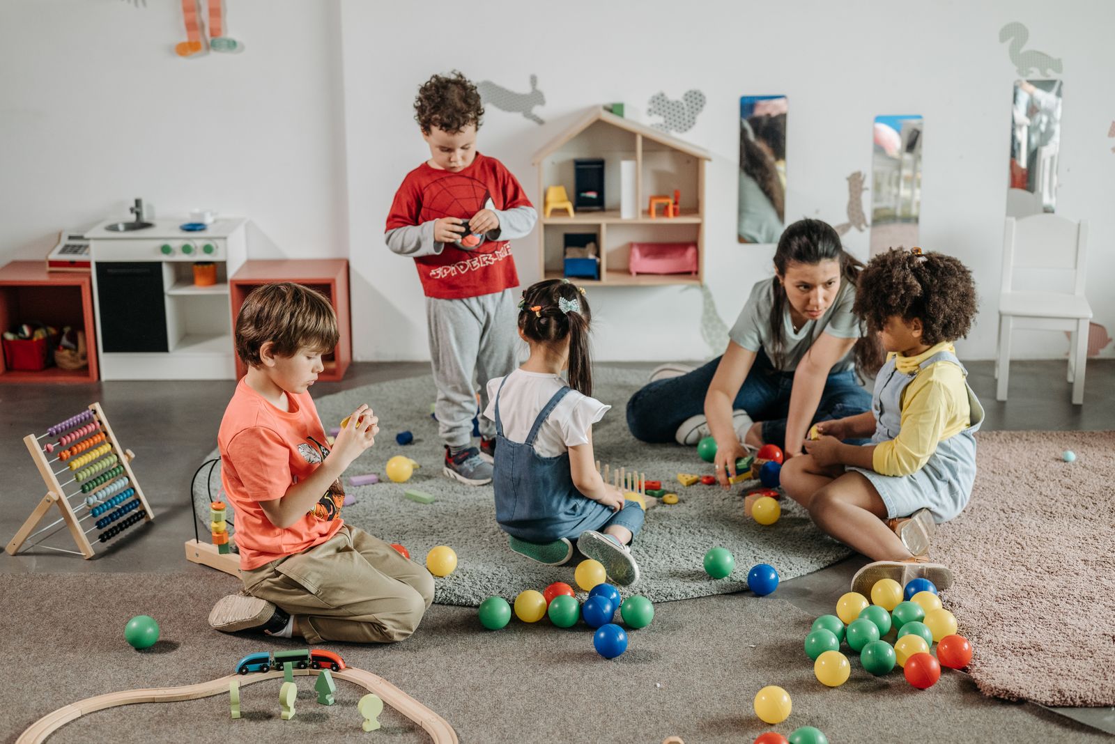 Children playing together with an educator at The Playhouse Creche and Playschool