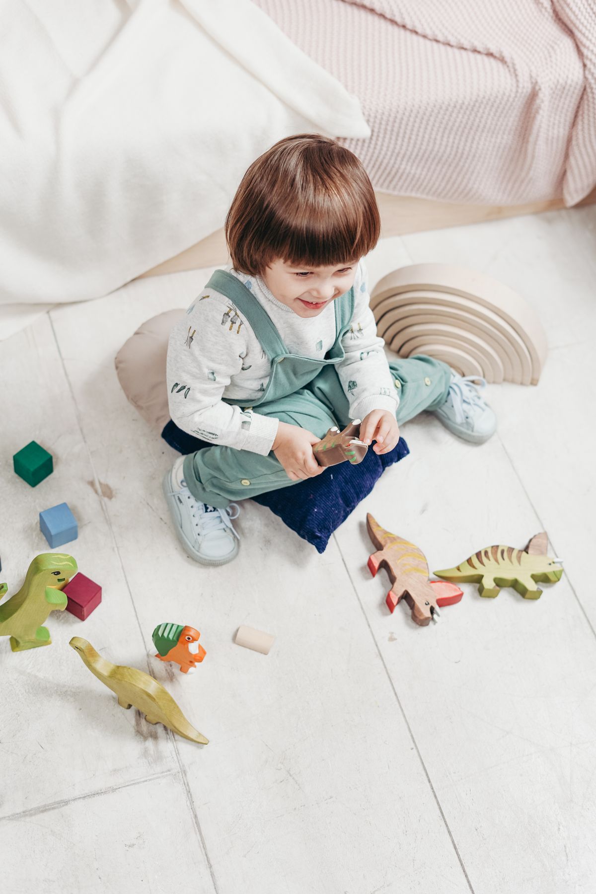 Child playing with wooden toys at The Playhouse